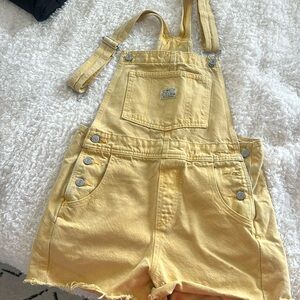 Levi’s yellow distressed short overalls